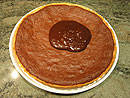  Warm the ganache until its melted and liquid, then spread it quickly over the top of the tart