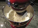 add to the flour on low speed until slightly larger than pea size pieces of butter remain
