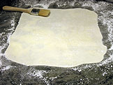 Use a pastry brush to remove the excess powdered sugar